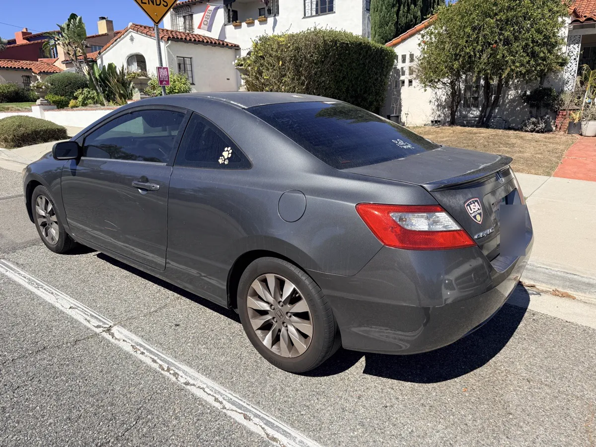 Gray Honda Civic coupe, rear three-quarter view