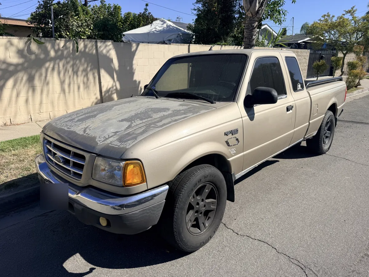 Tan Ford Ranger pickup parked on a residential street, front three-quarter view
