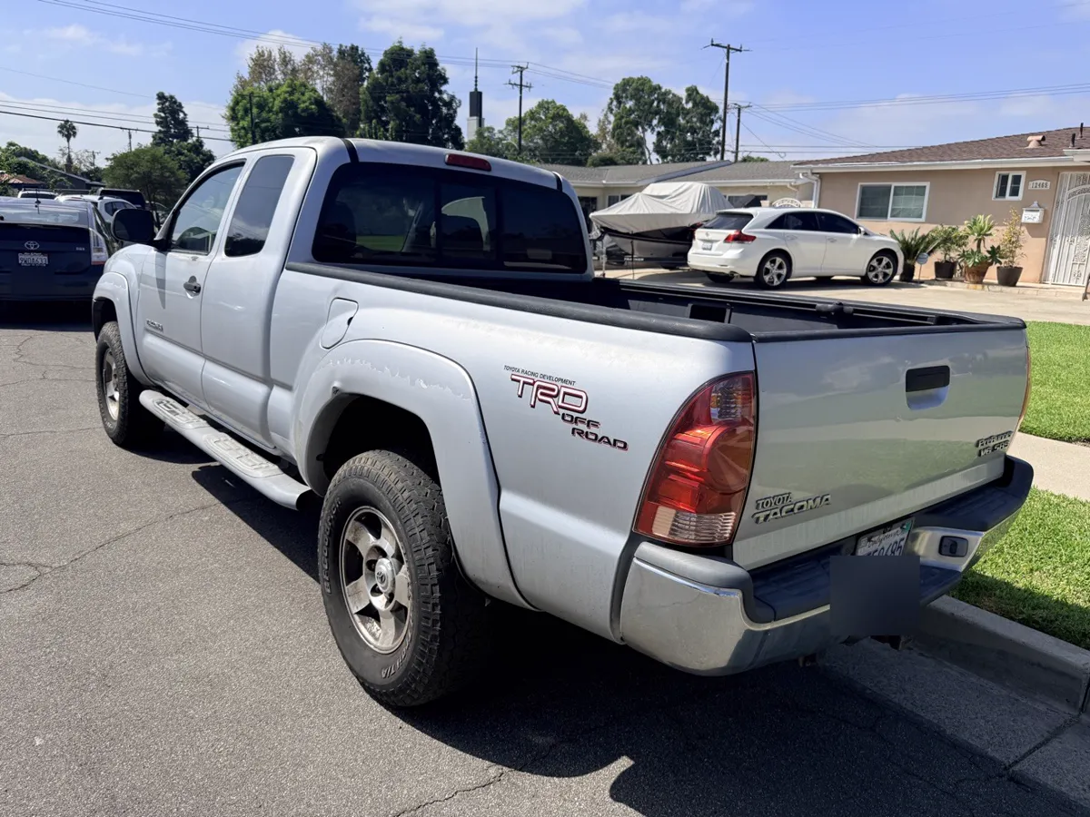 Silver Toyota Tacoma TRD Off-Road pickup, rear three-quarter view