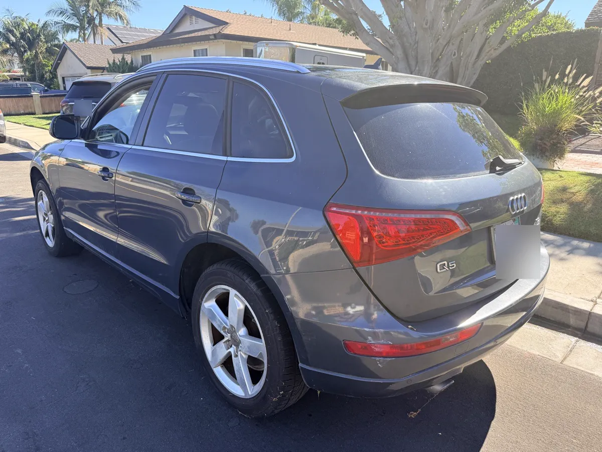 Gray Audi Q5 SUV, rear three-quarter view