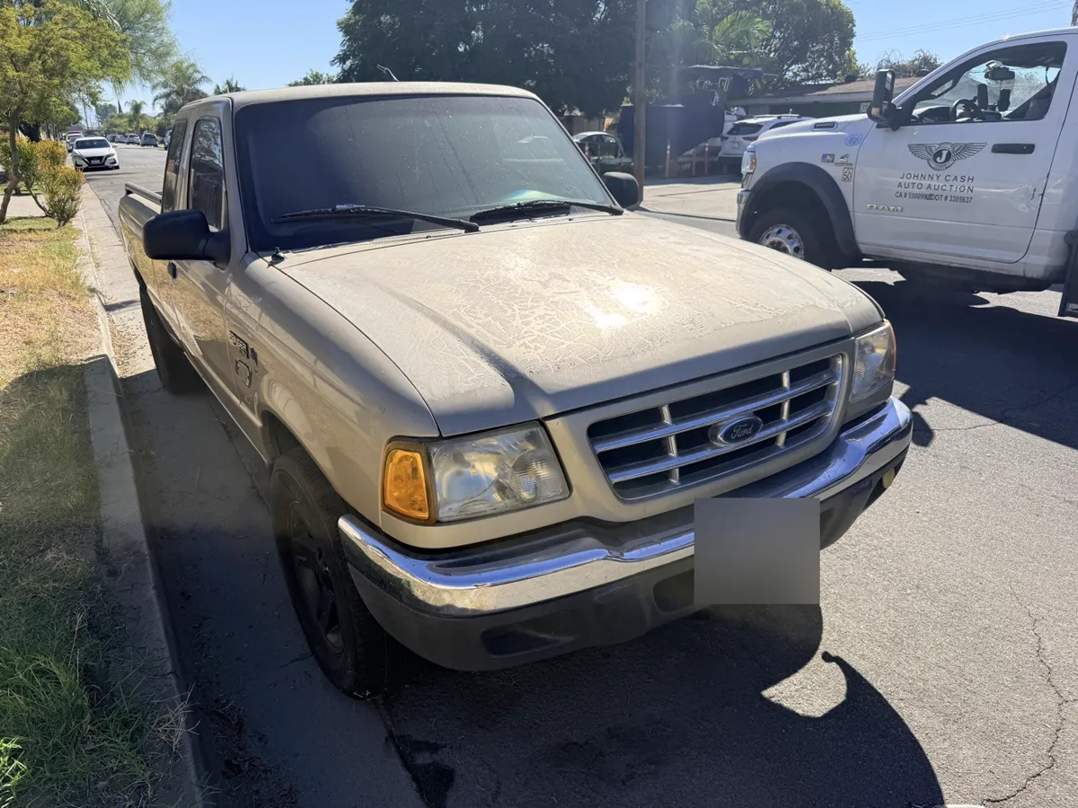 Tan Ford Ranger pickup, side view