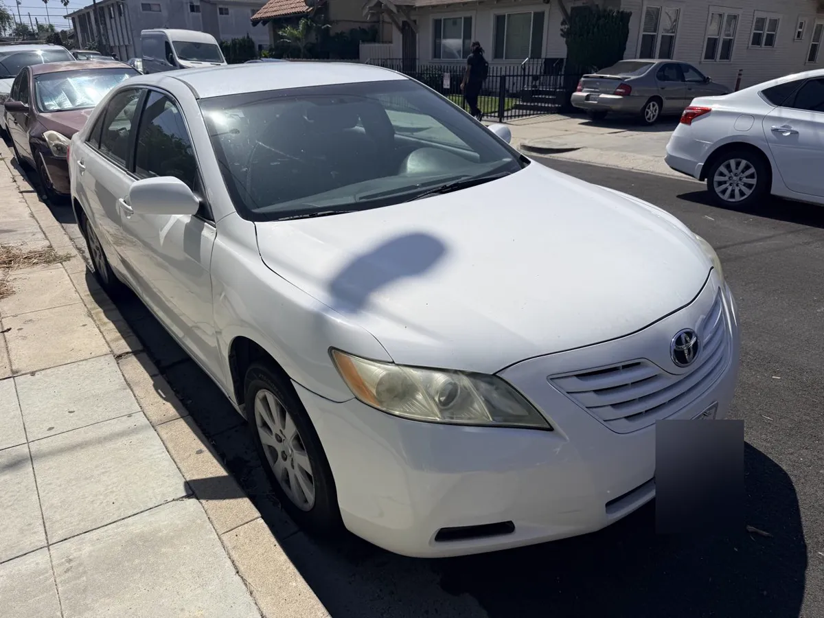 White Toyota Camry, front three-quarter view