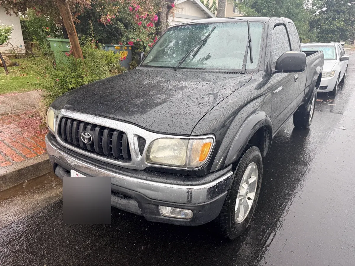 Black Toyota Tacoma TRD pickup, front three-quarter view